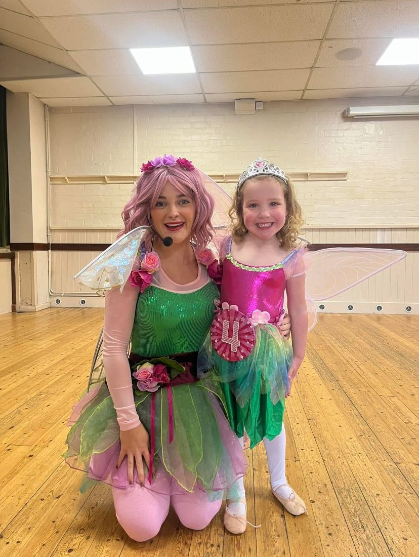 Party entertainer and child at a fairy themed party