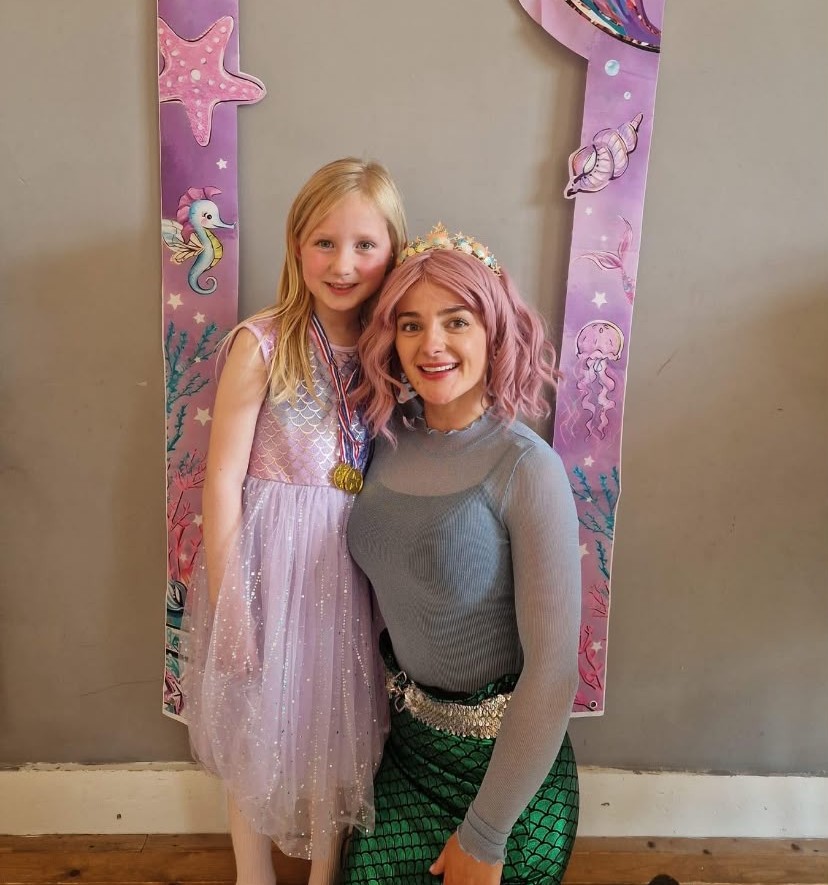 Child in a mermaid costume at a party