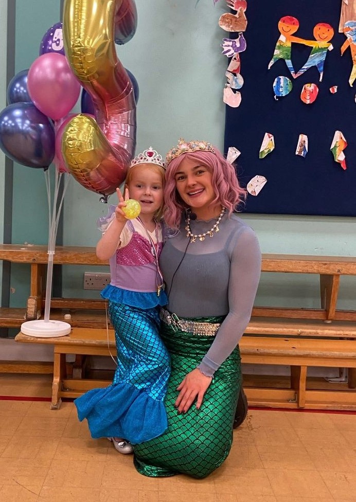 Party entertainer and child at a mermaid themed party